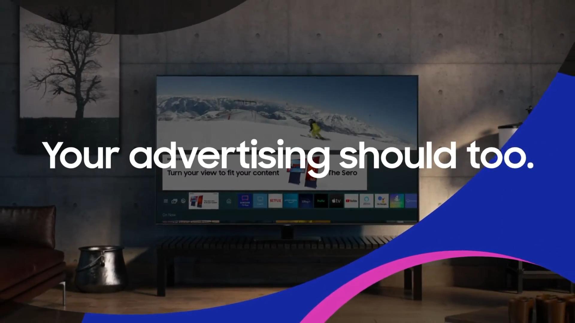 Still frame from Samsung's video. A television is shown. The television shows a skier on a mountain slope, but the lower half of the screen is obscured by large interface elements and an advertisement.