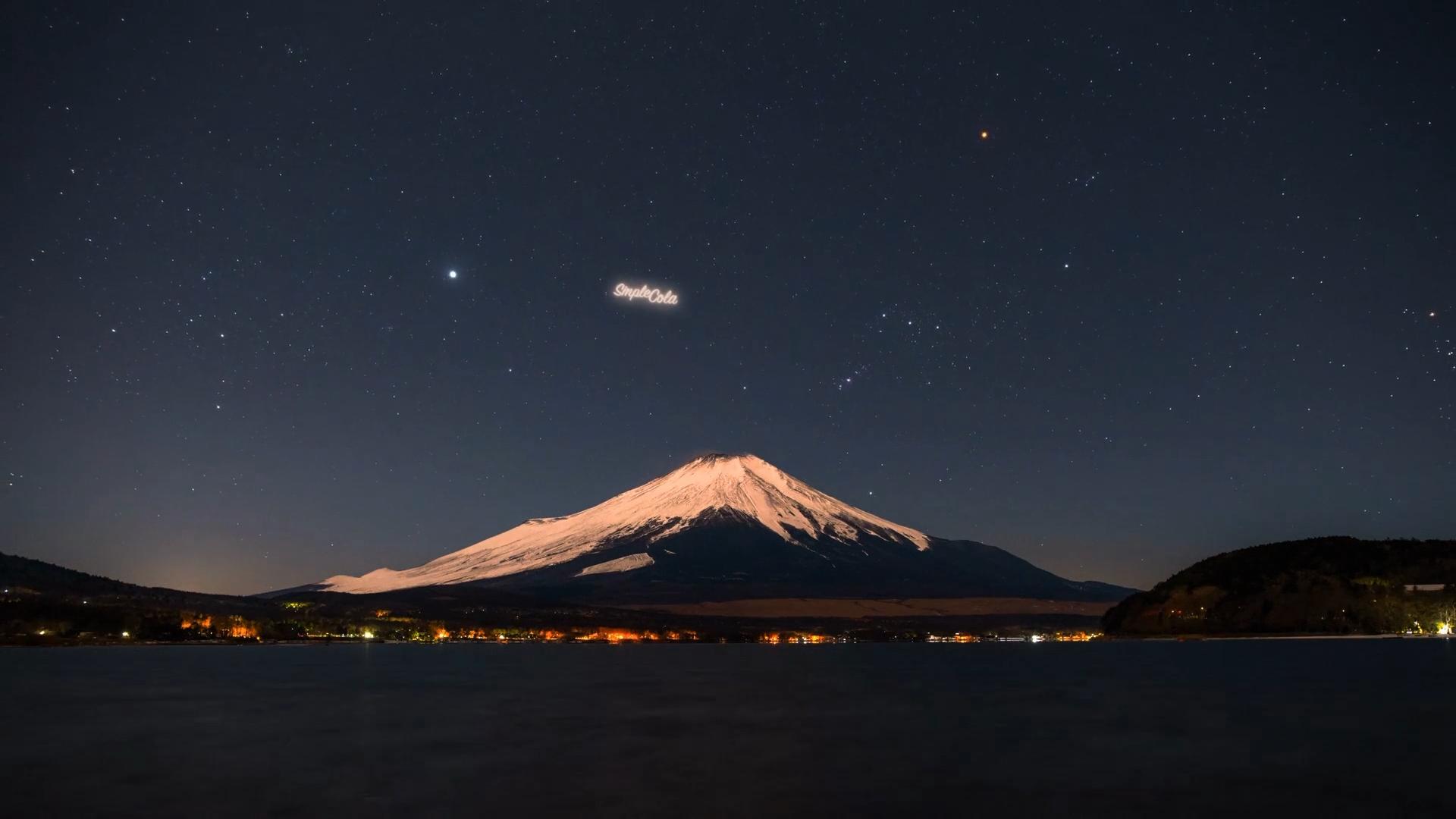 A still frame from StartRocket's promotional video shows Mount Fuji, with the brightly illuminated name Simple Cola suspended in the night sky.